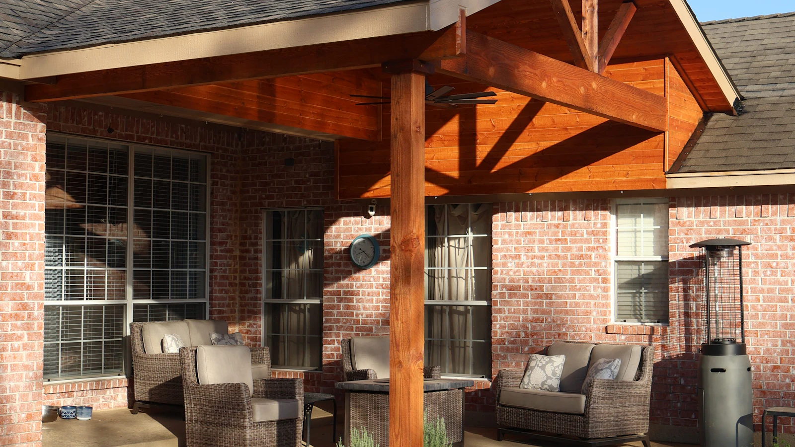 Cedar-framed gable patio cover over an outdoor seating area